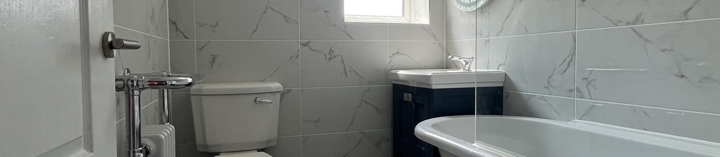 Bathroom renovation with roll-top bath completed by AJB Plumbing & Heating