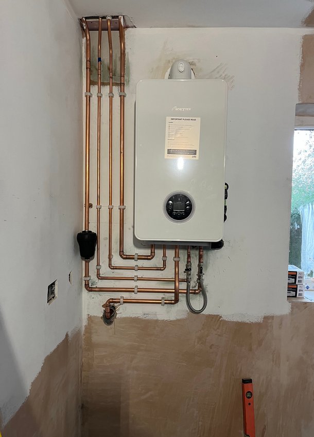 Wall-mounted boiler with neatly arranged copper pipework