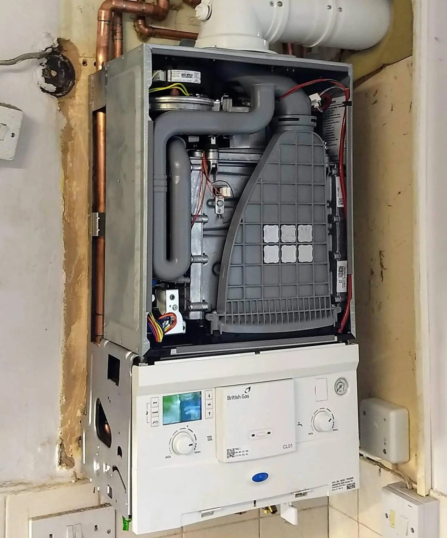 Engineer carrying out a boiler service in Bolton home