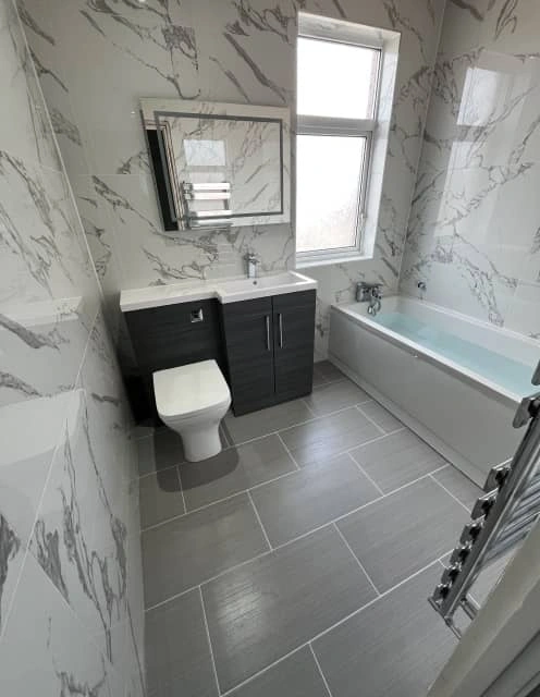 After: Fresh bathroom with new fixtures and classic white style