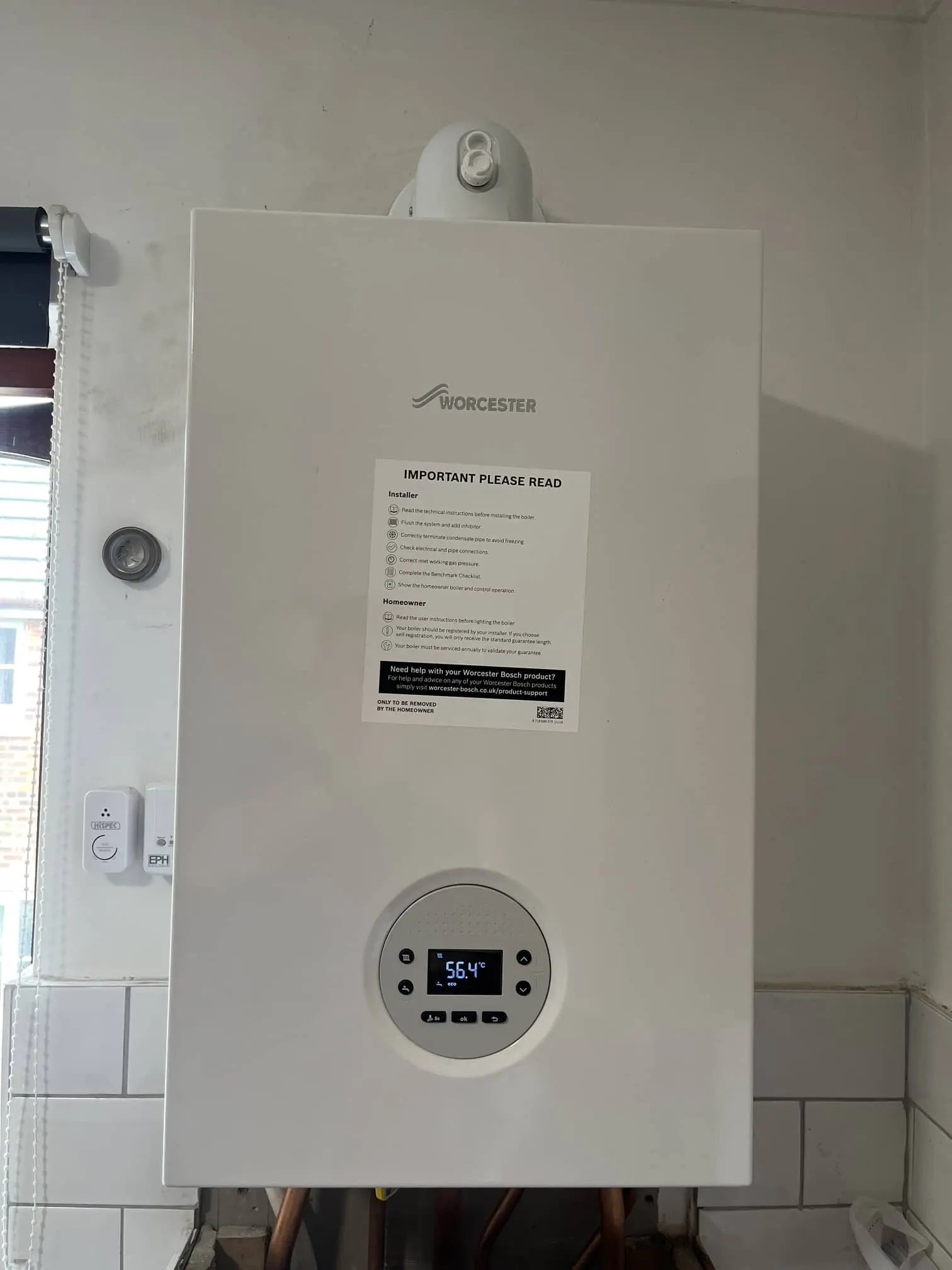New domestic boiler installed neatly in a cupboard